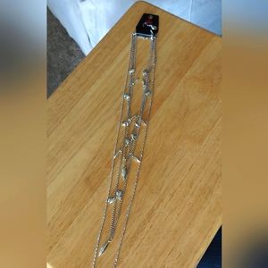 Paparazzi Sliver 3 layer necklace with matching earrings.